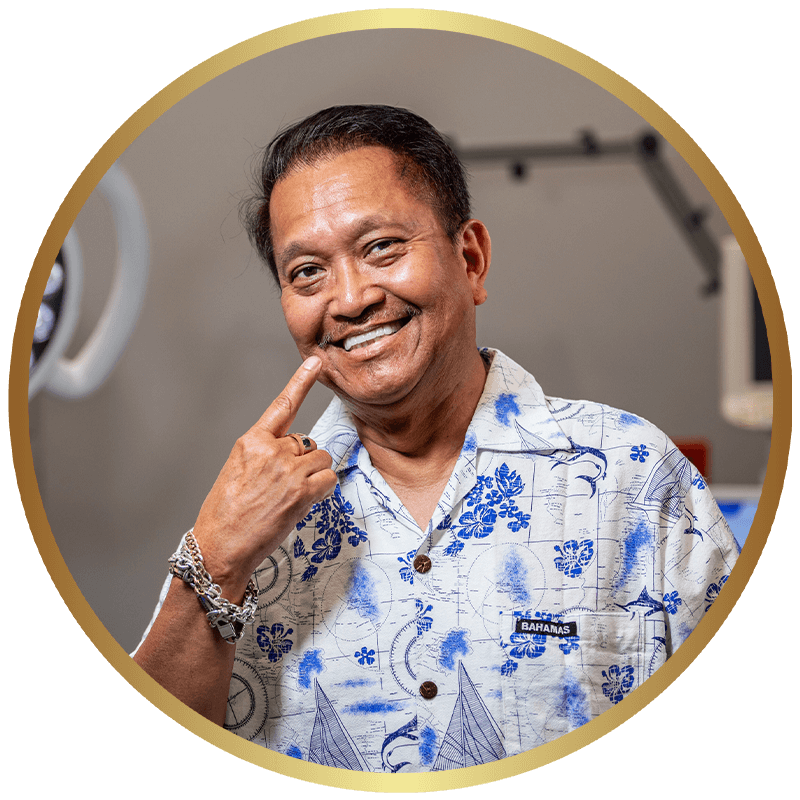 A patient smiling after completing implant treatment at ADHP