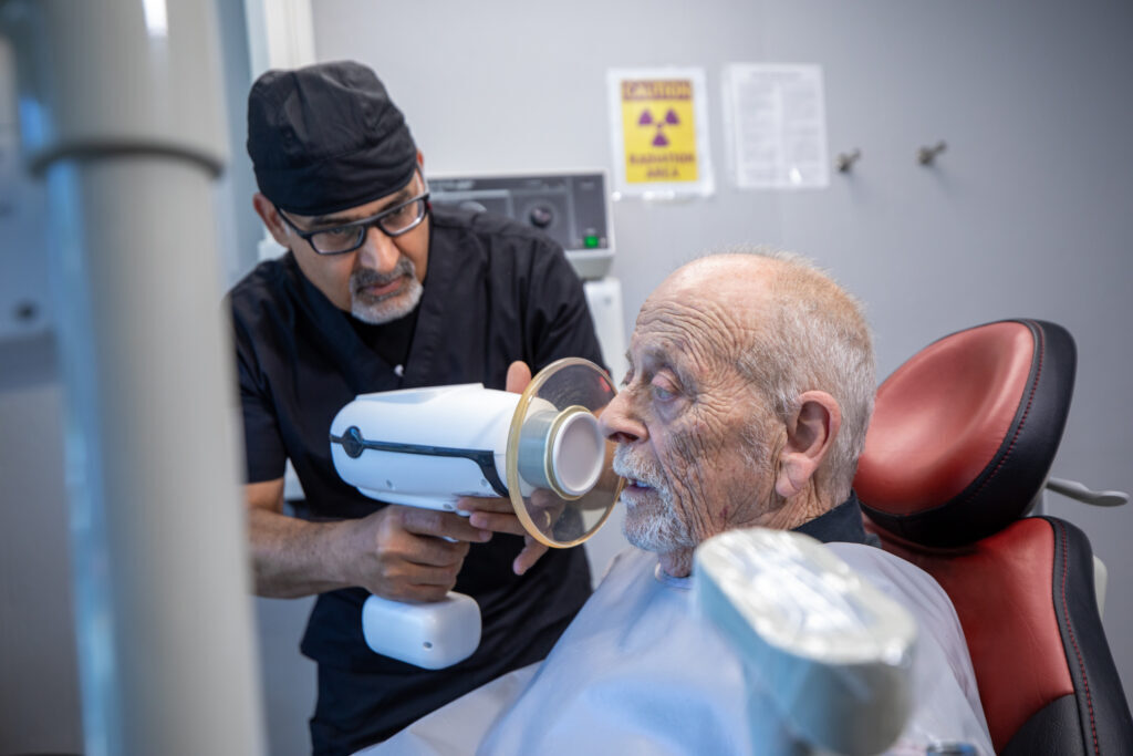 An ADHP dentist using imaging technology with a patient